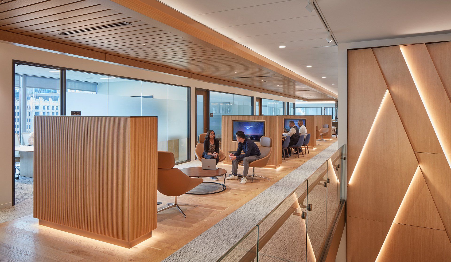 A group of people are sitting in chairs in a large room.