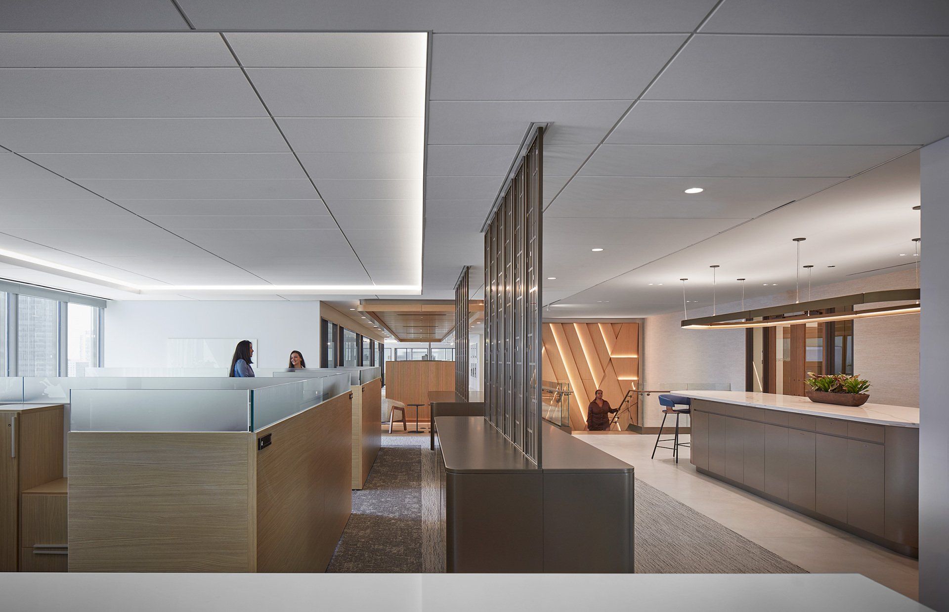 An artist 's impression of a large office building with cubicles and a reception desk.