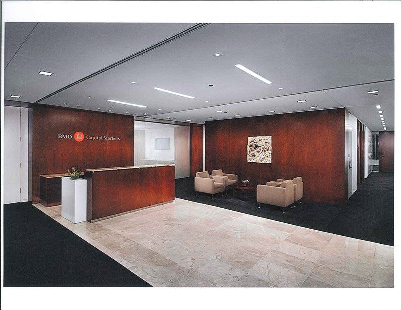 A picture of a lobby with a reception desk and chairs