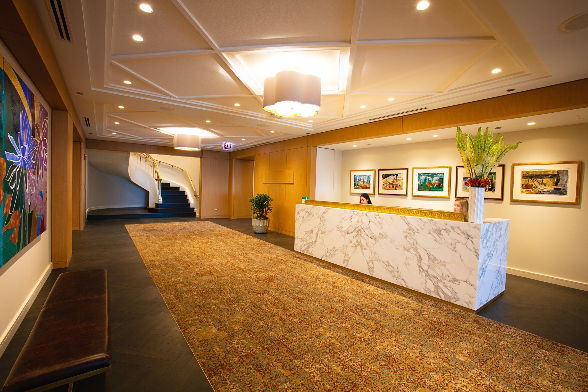 There is a marble counter in the middle of the hallway.