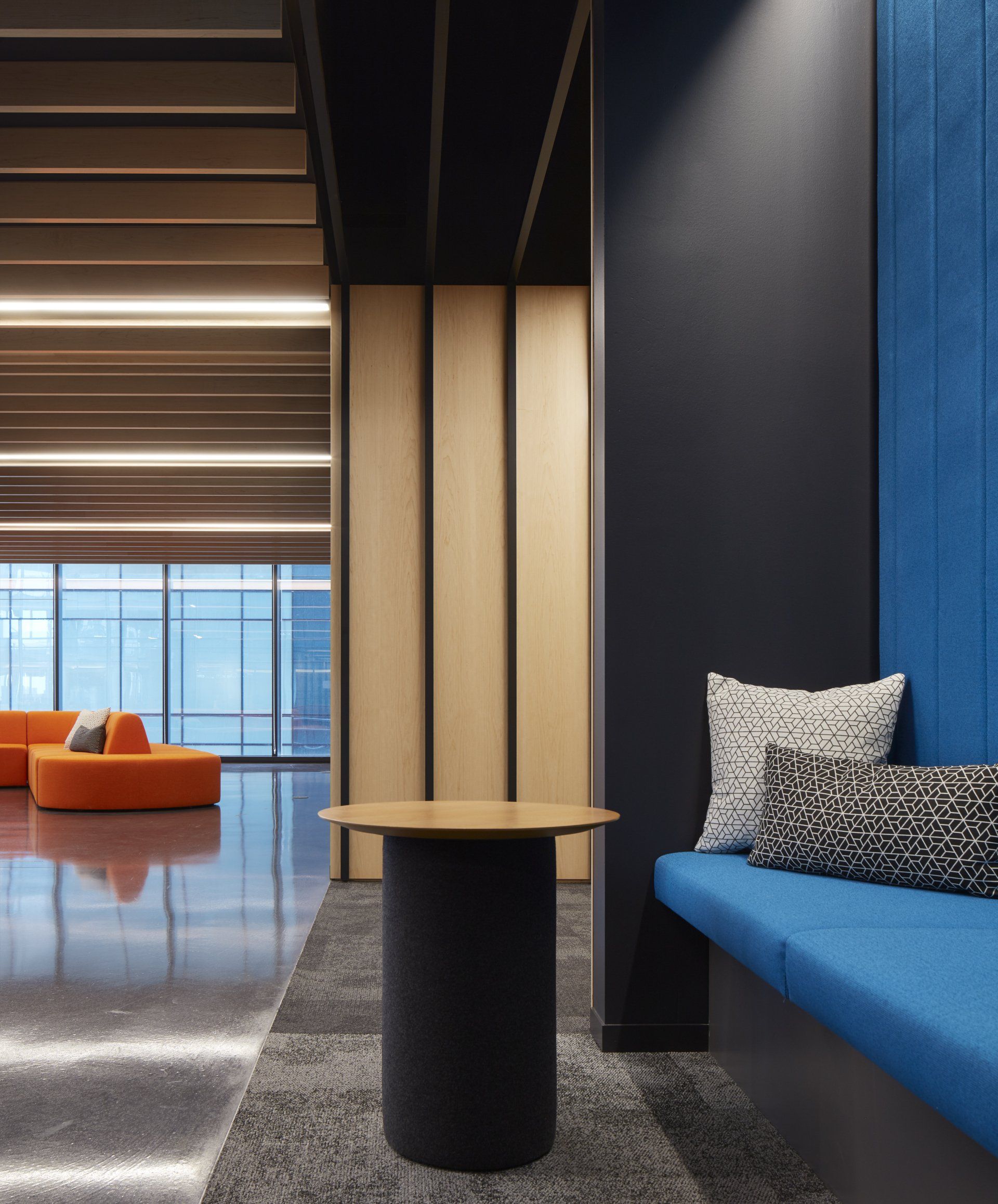 A room with a blue bench and a table