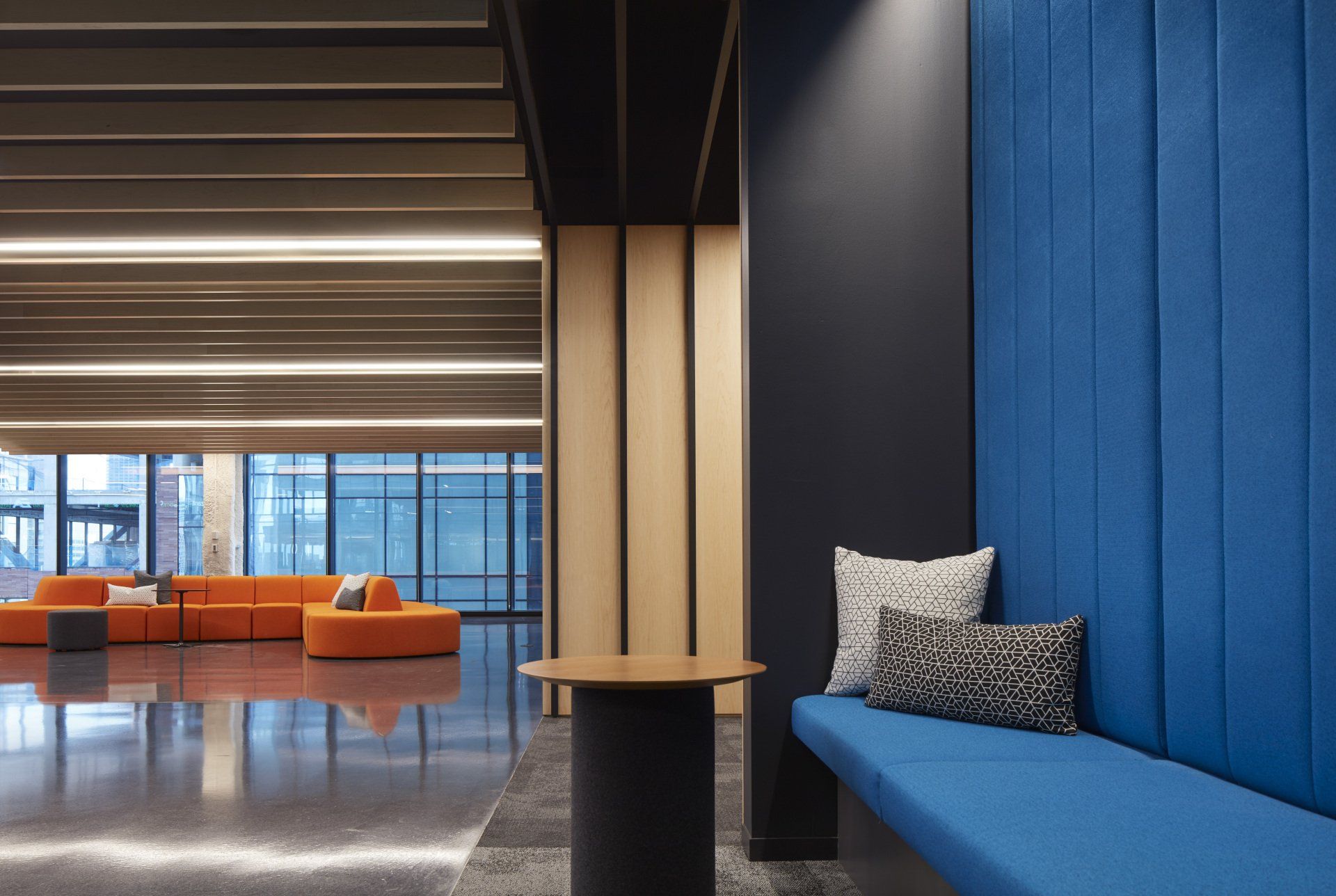 There is a blue bench in the middle of the room.