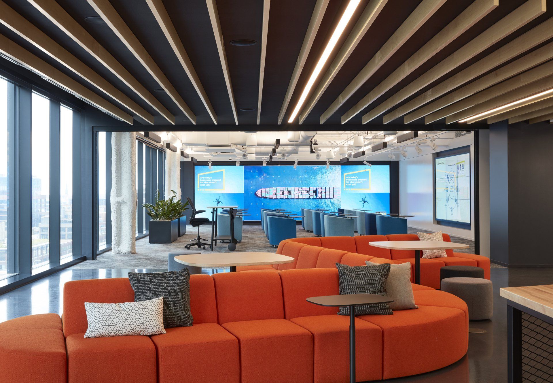 A large room with a couch and tables in it