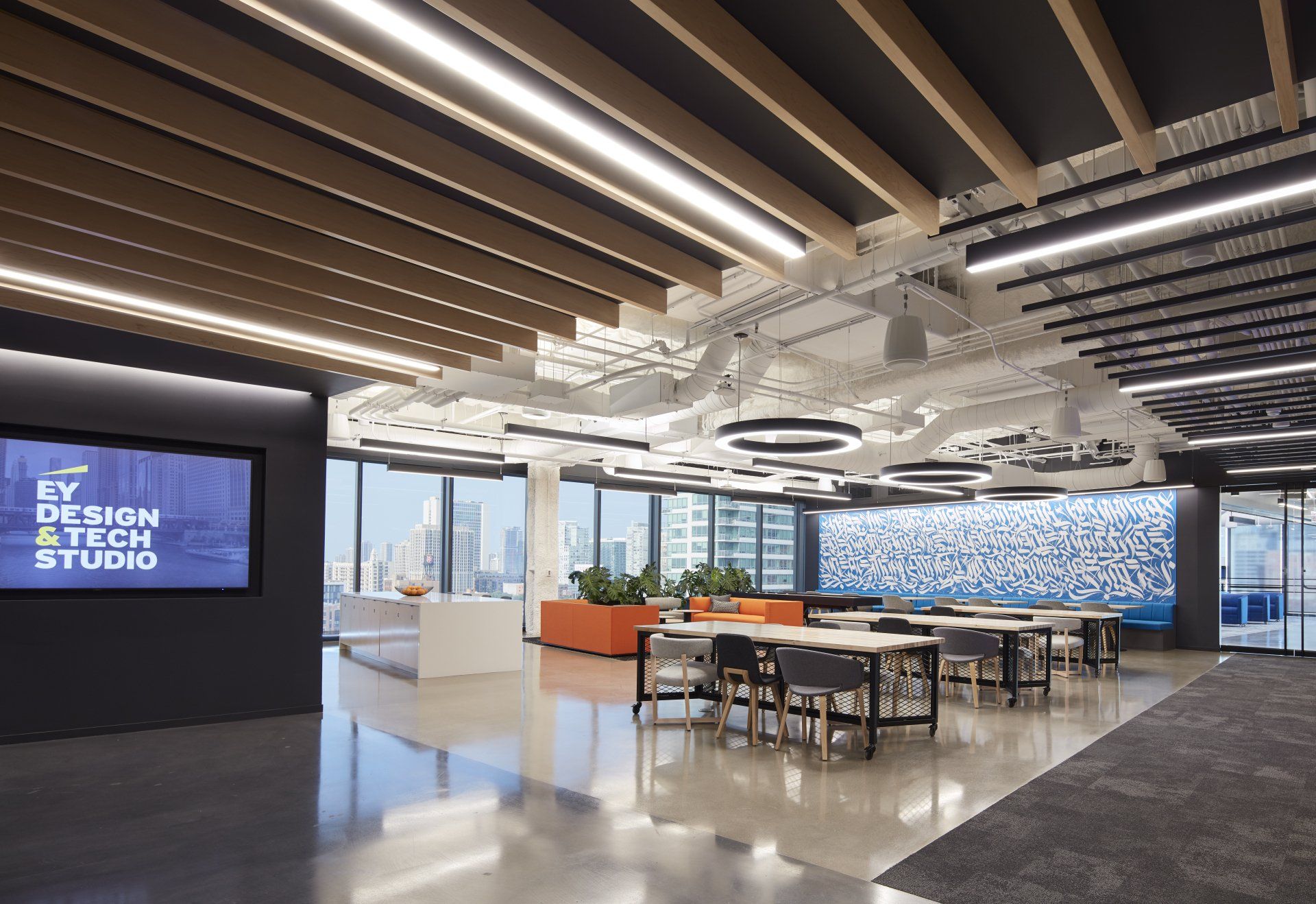 A large room with tables and chairs and a sign that says ey design & tech studio