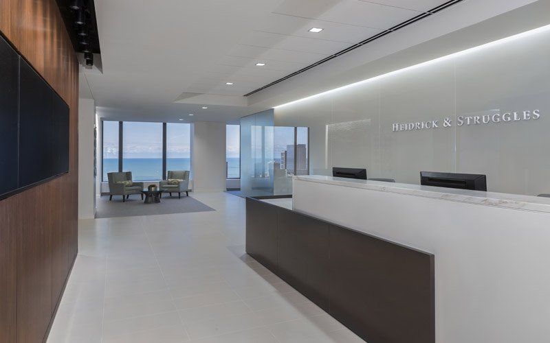 A large lobby with a large window and a reception desk.