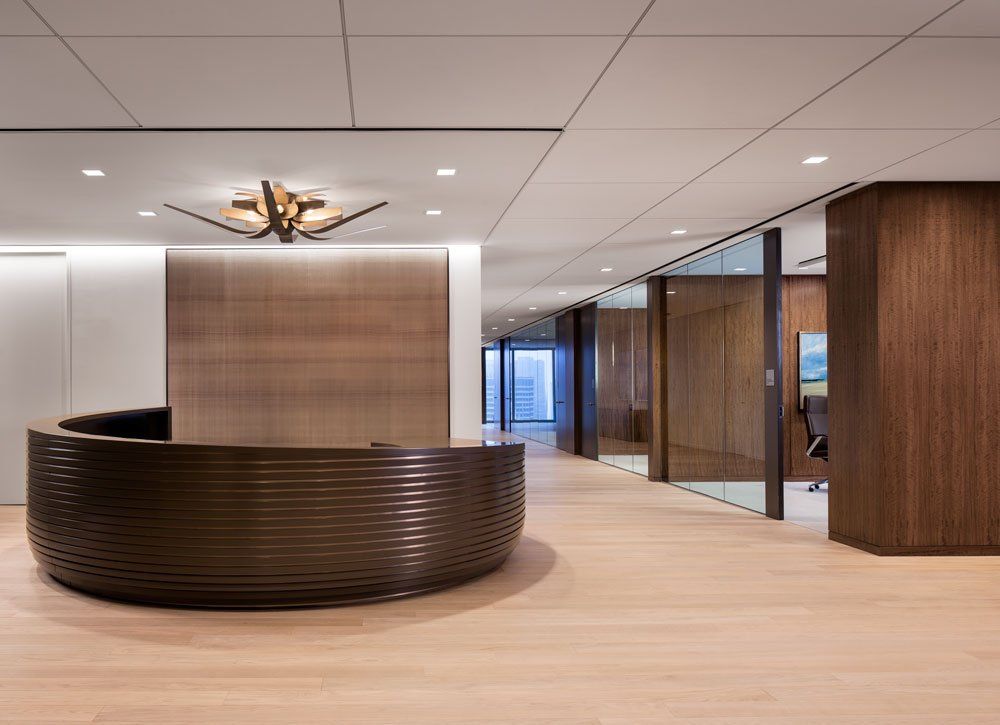 There is a round reception desk in the middle of the room.