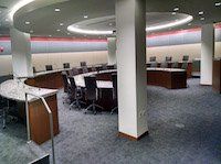 A large conference room with tables and chairs in it.