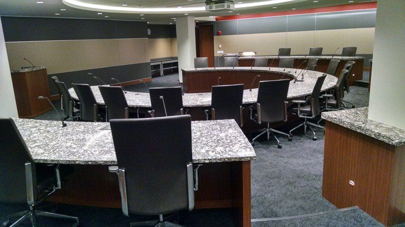 A conference room with a round table and chairs