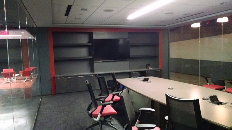 A conference room with a long table and chairs