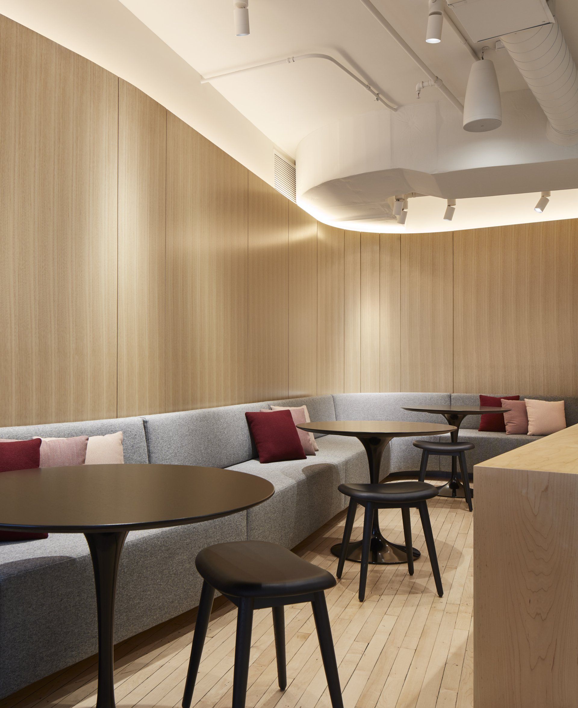 A room with tables and stools and a couch