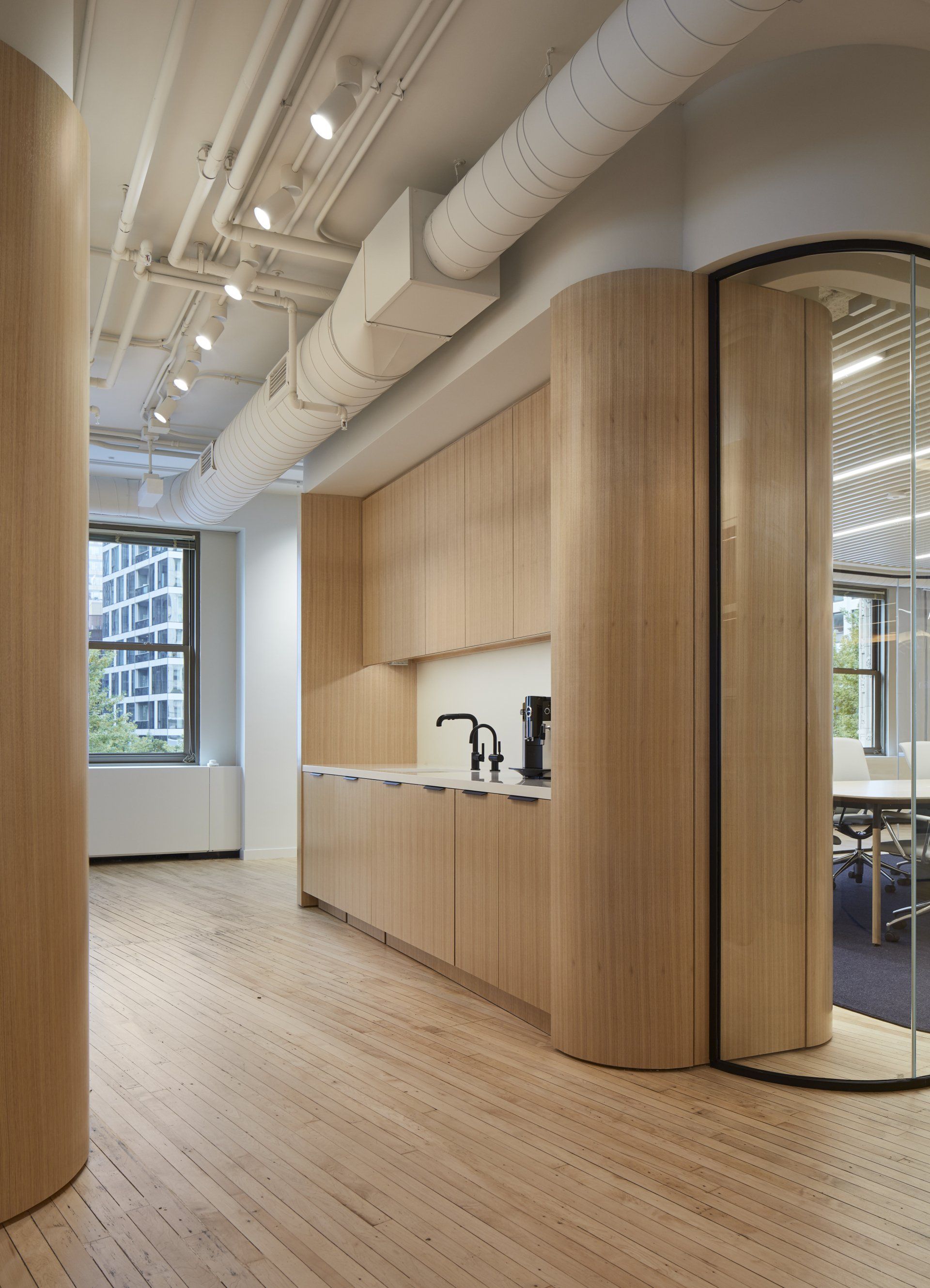 A kitchen with wooden cabinets and a glass door