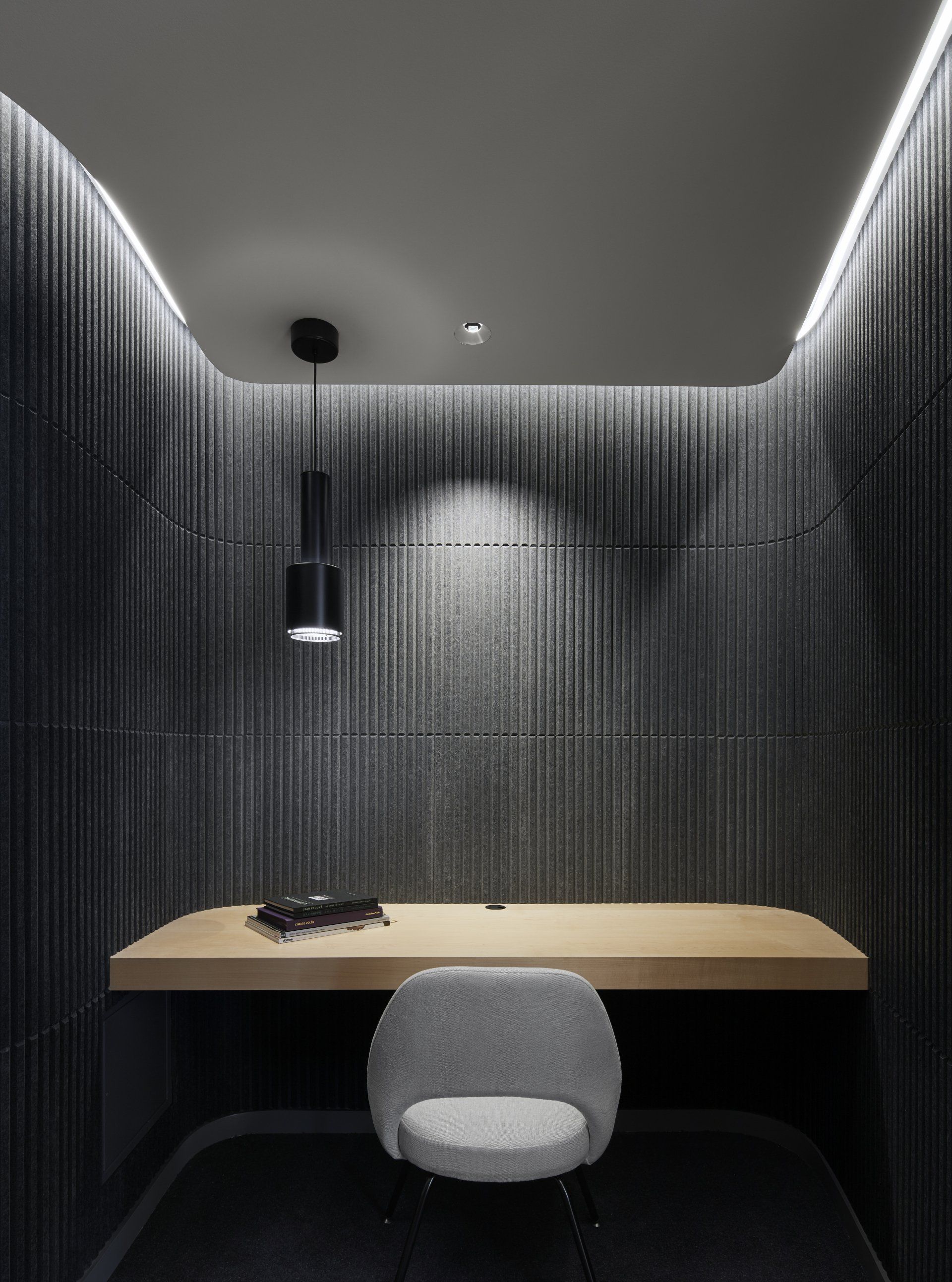 A small room with a desk and chair in it