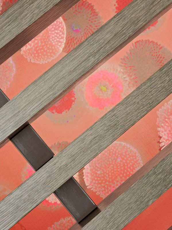 A close up of a wooden fence with flowers on it.