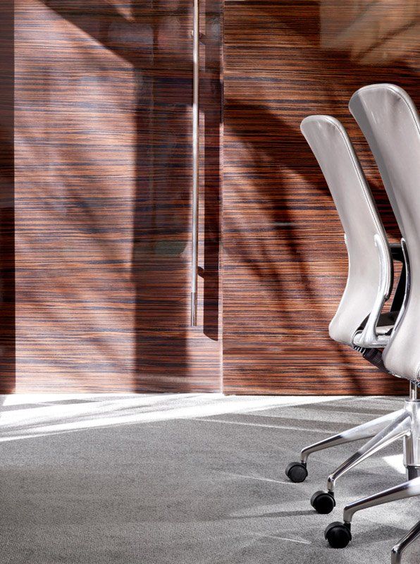 A row of white office chairs in a conference room