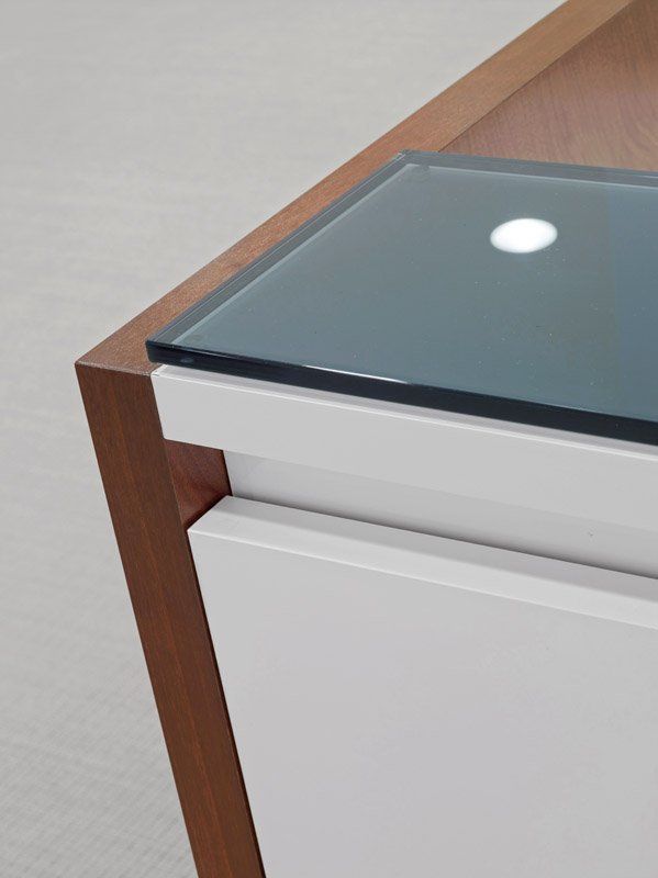 A white cabinet with a glass top and a wooden frame