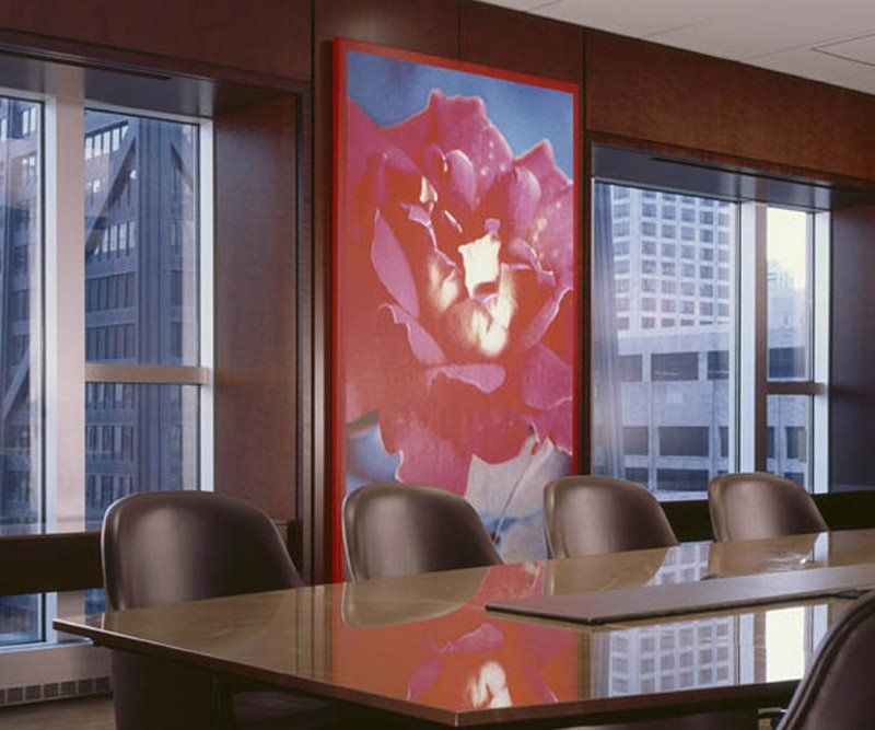 A conference room with a large painting of a flower on the wall