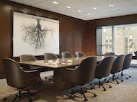 A conference room with a long table and chairs.