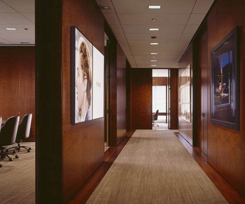 A hallway with a picture of a woman on the wall