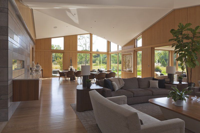 A living room with a lot of furniture and a vaulted ceiling