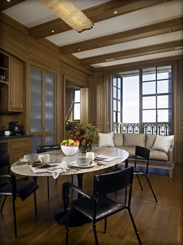 A dining room with a round table and chairs