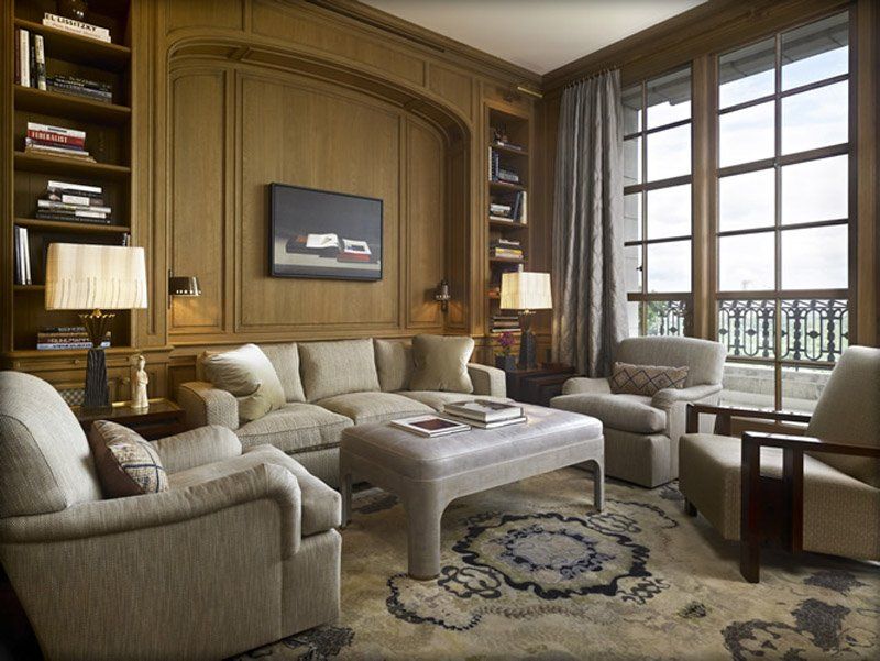 A living room with a couch , chairs , and a coffee table