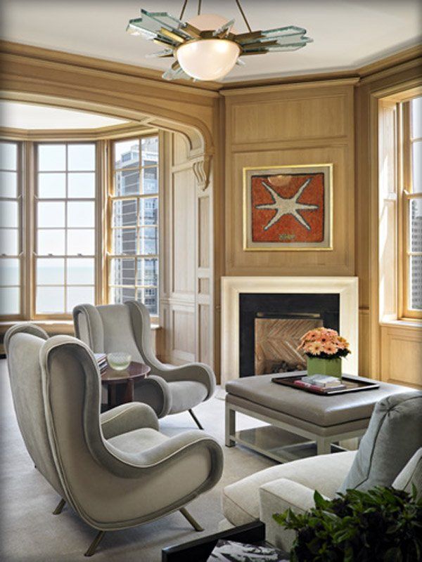 A living room with two chairs and a fireplace