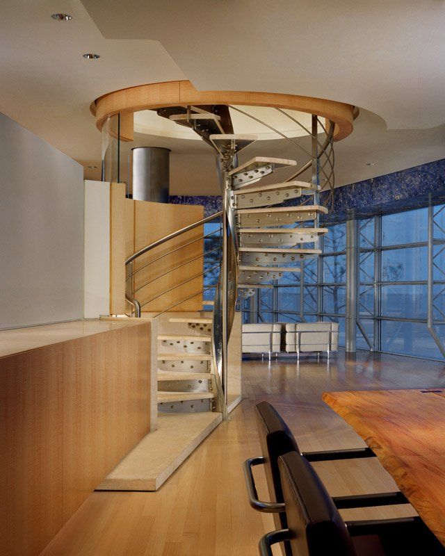 A spiral staircase is in the middle of a room