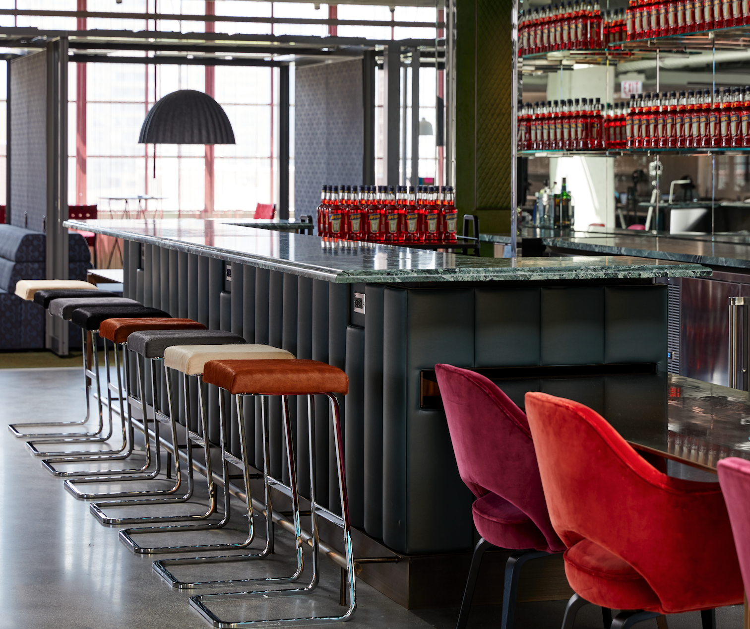 A restaurant with a long bar and stools