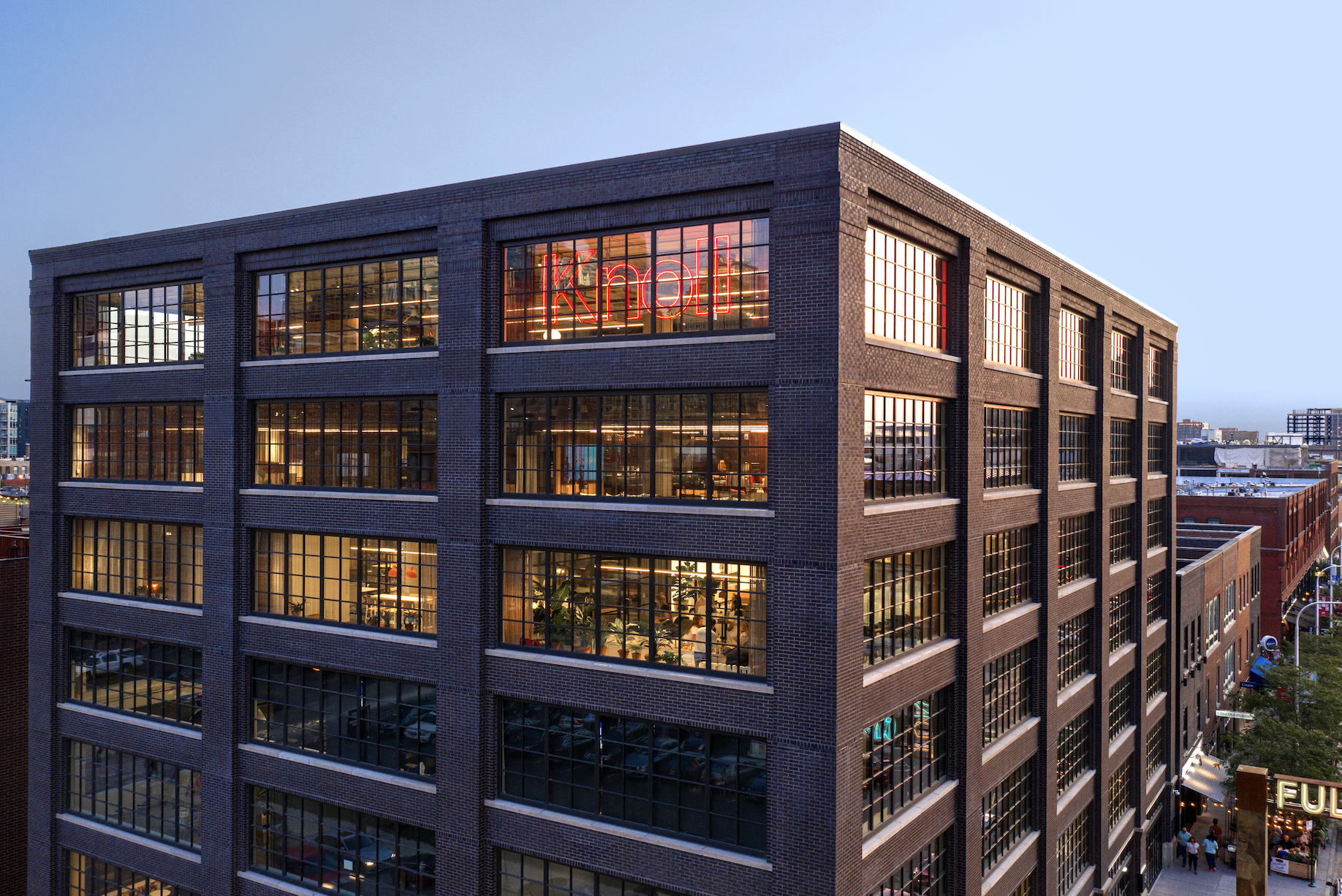 An aerial view of a large brick building with lots of windows.