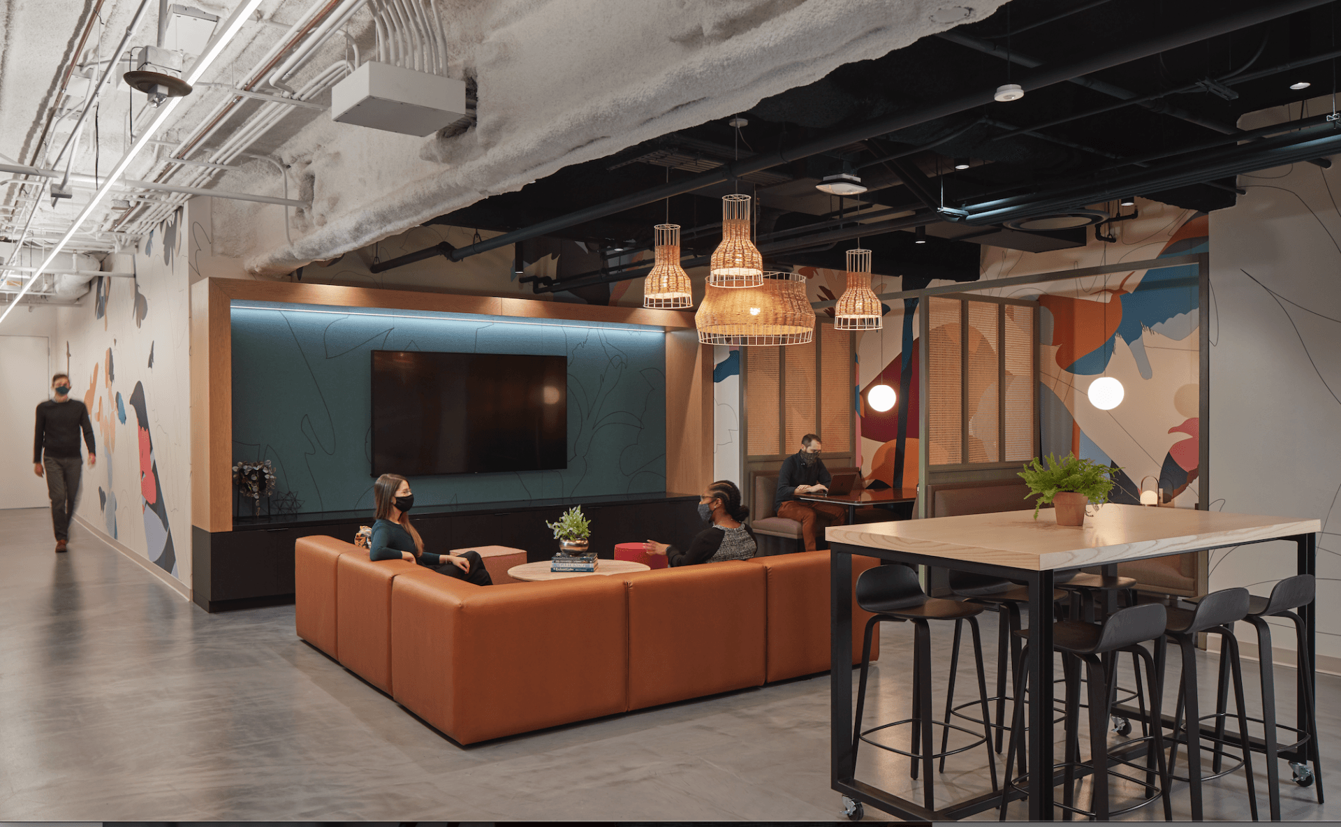 A group of people are sitting on a couch in a living room.