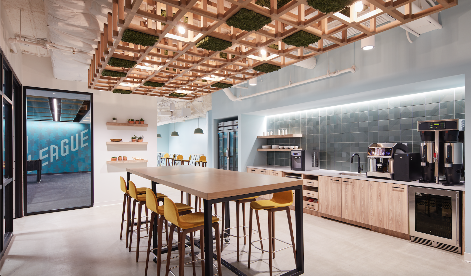 A kitchen with a long table and chairs in it.