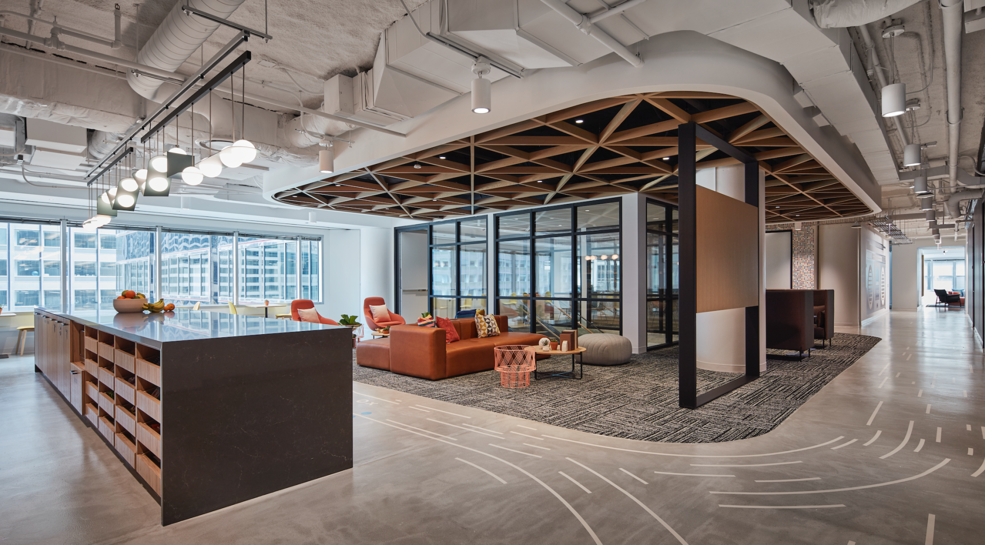 A large room with a lot of windows and furniture in it.