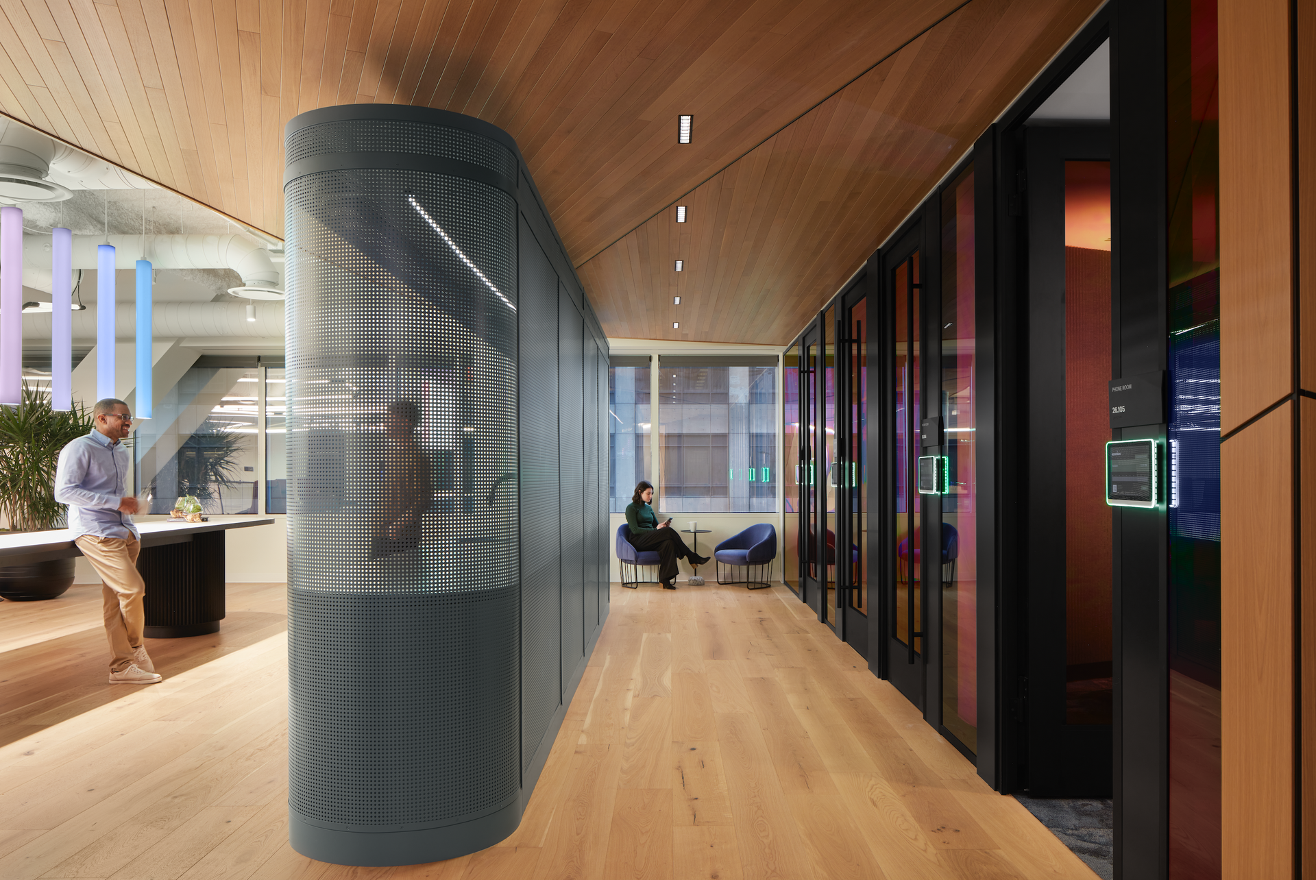 An artist 's impression of a hallway with people sitting in chairs.