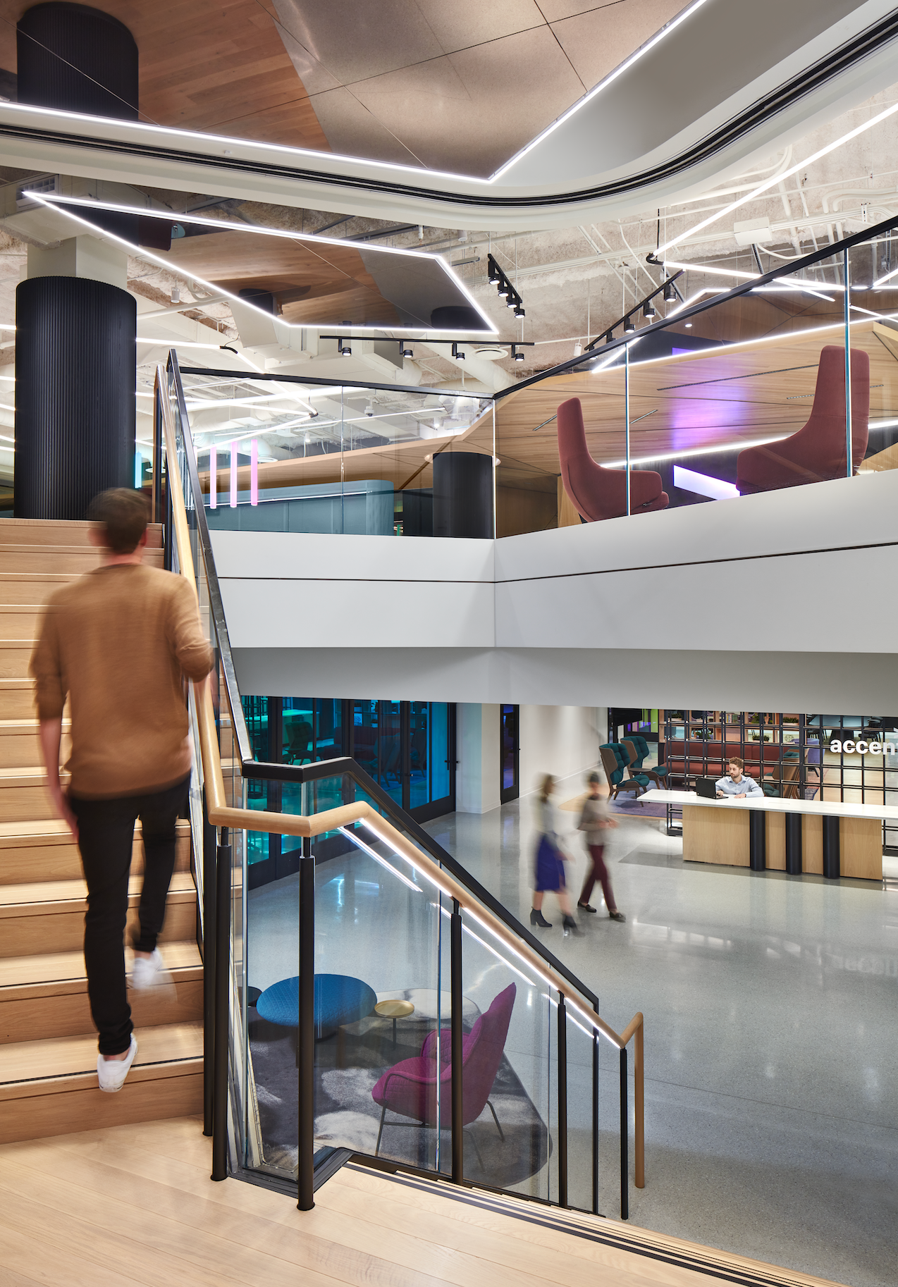 A man is walking down a set of stairs in a building.
