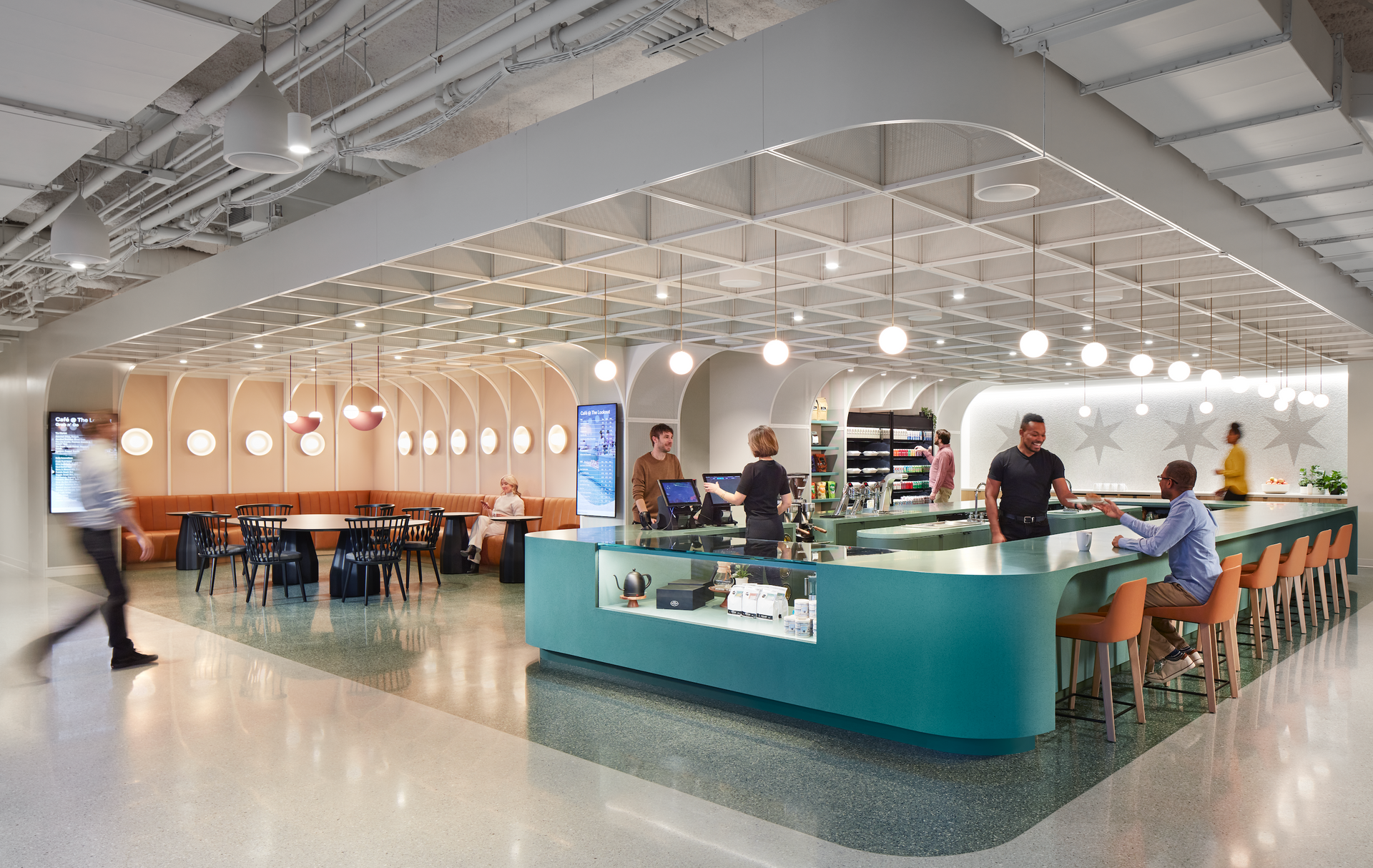 A group of people are sitting at tables in a restaurant.