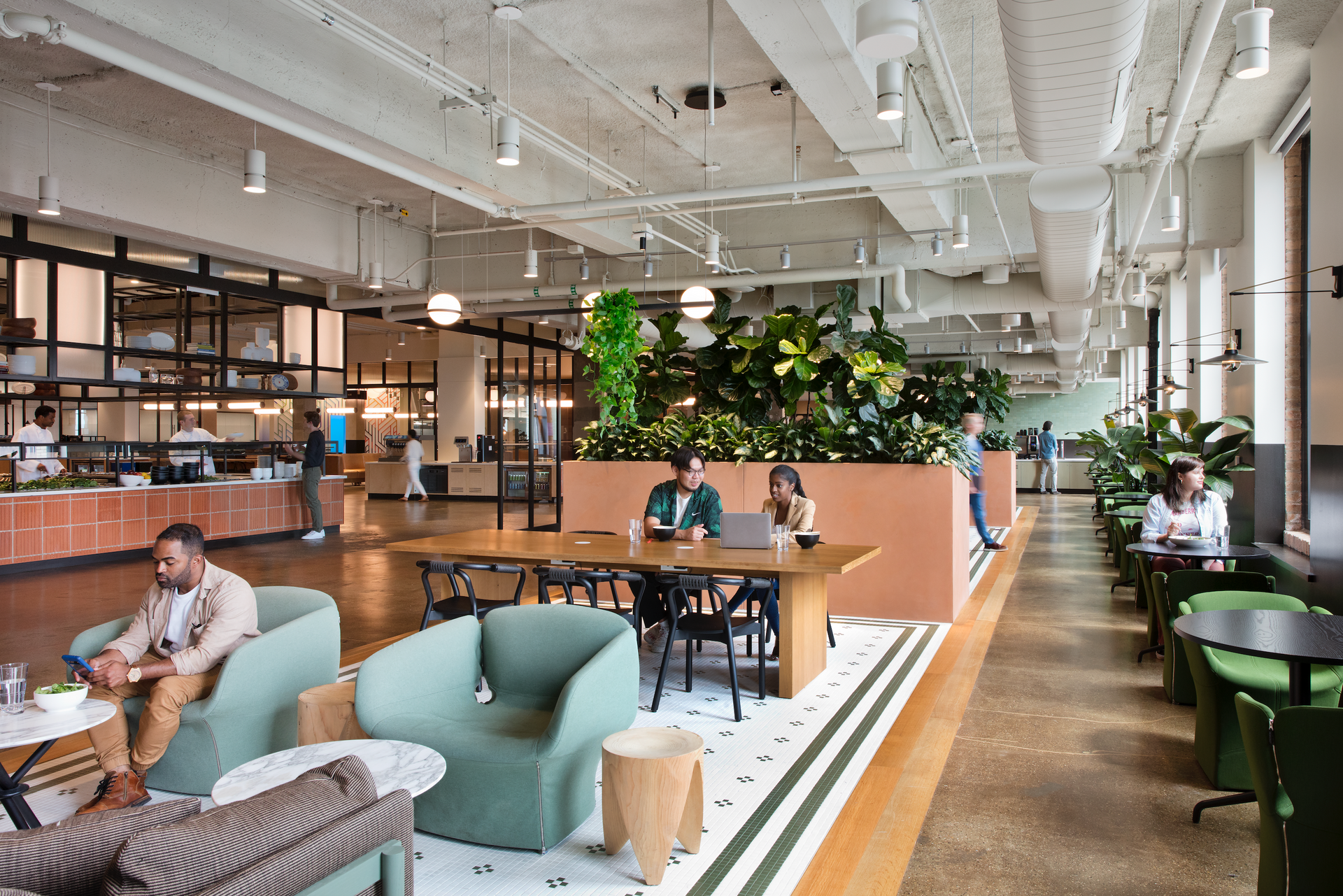 A group of people are sitting at tables in a large room.