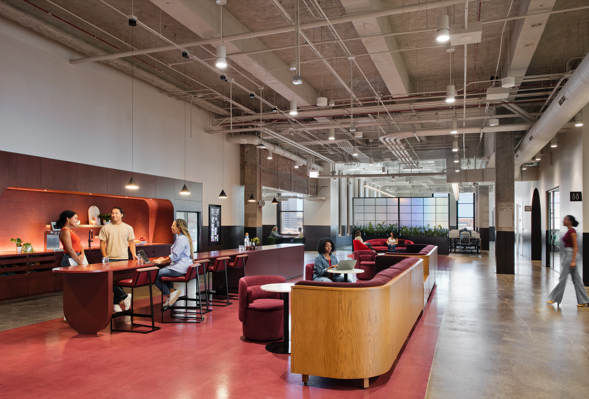 A group of people are standing in a large room.
