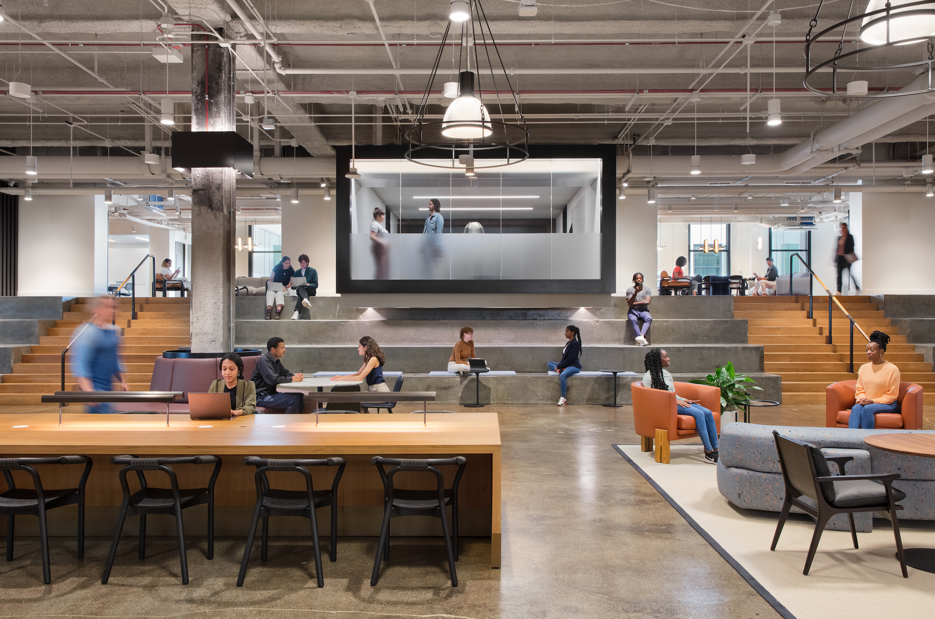 A group of people are sitting at tables in a large room.