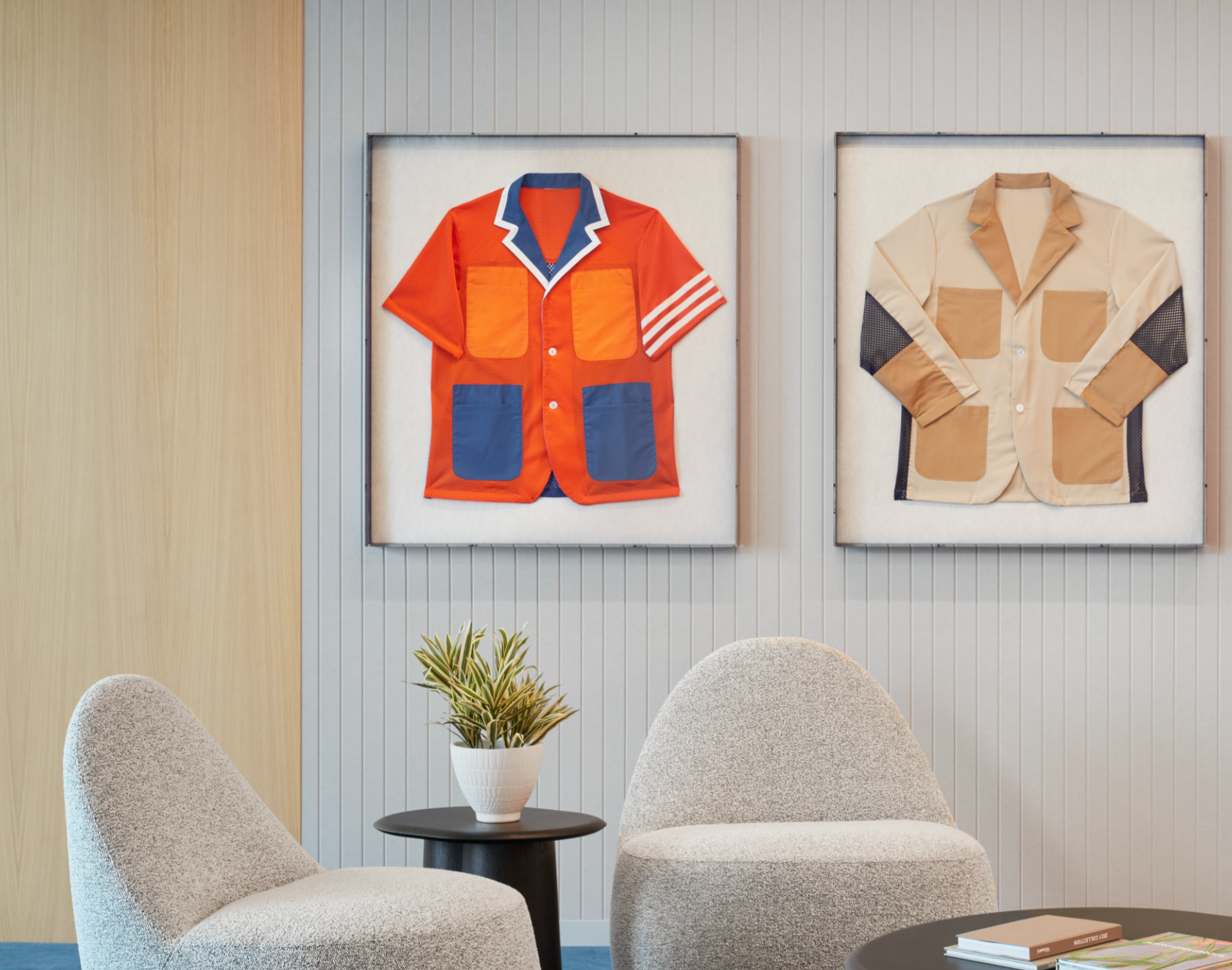 A living room with two chairs and two paintings on the wall