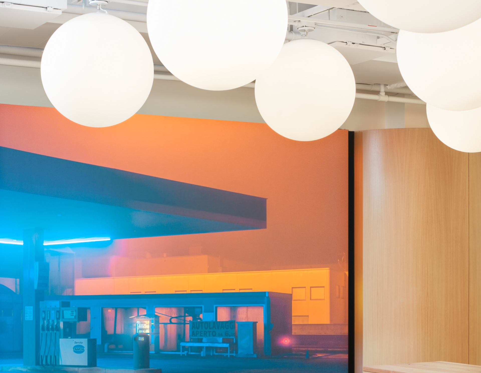 A room with a picture of a gas station on the wall