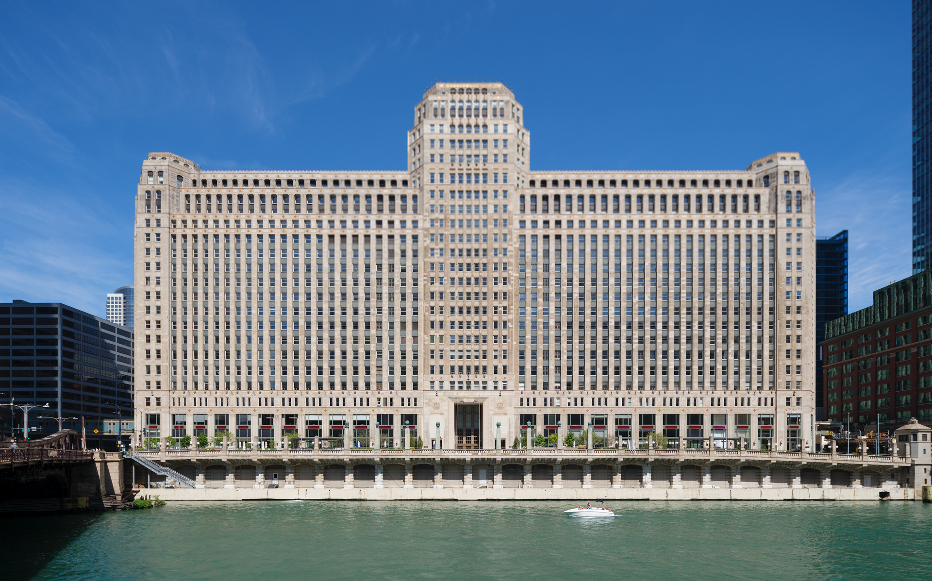 A large building is sitting next to a body of water.