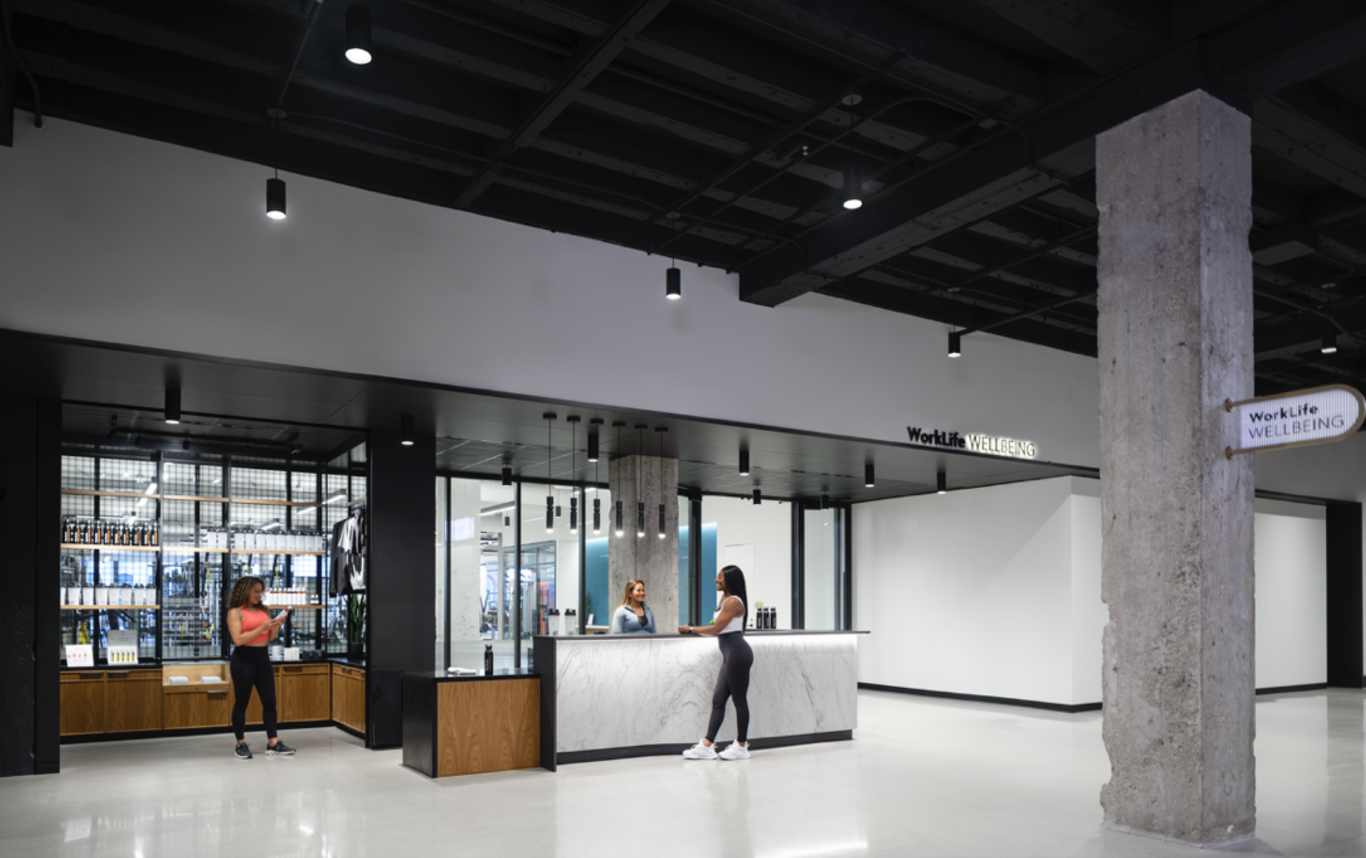 A woman is standing at a counter in a large room