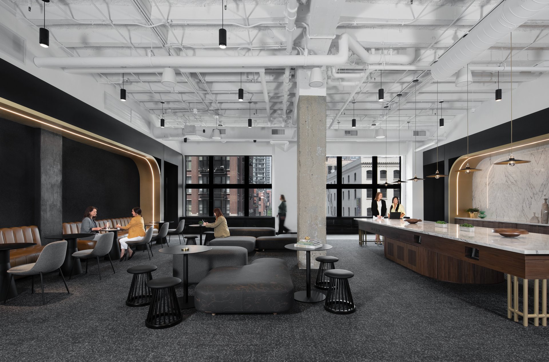 A large room with a pool table , couch , chairs and tables.