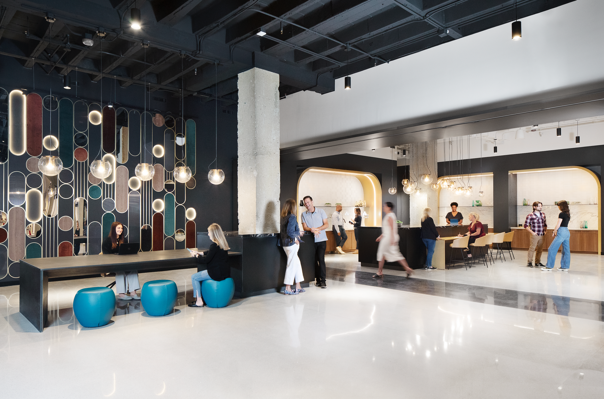 A group of people are standing in a lobby of a building.