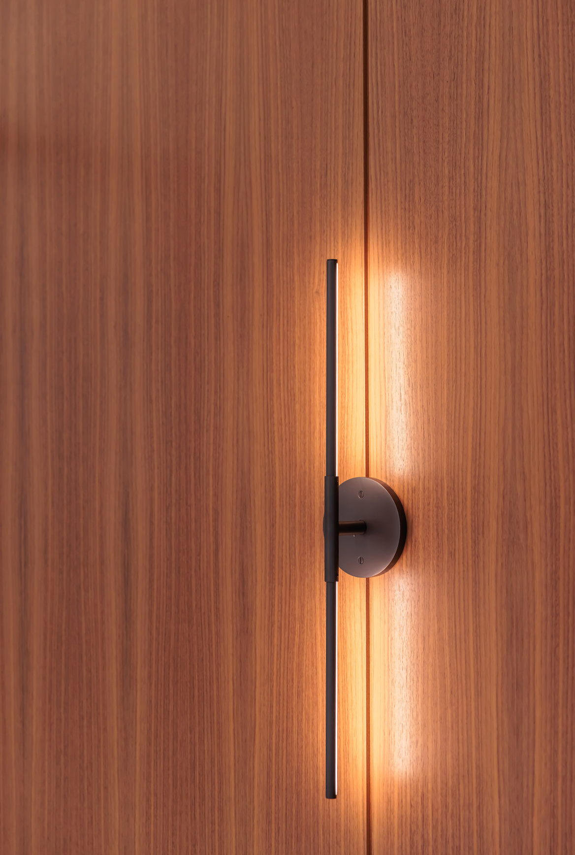 A light is shining on a wooden door.
