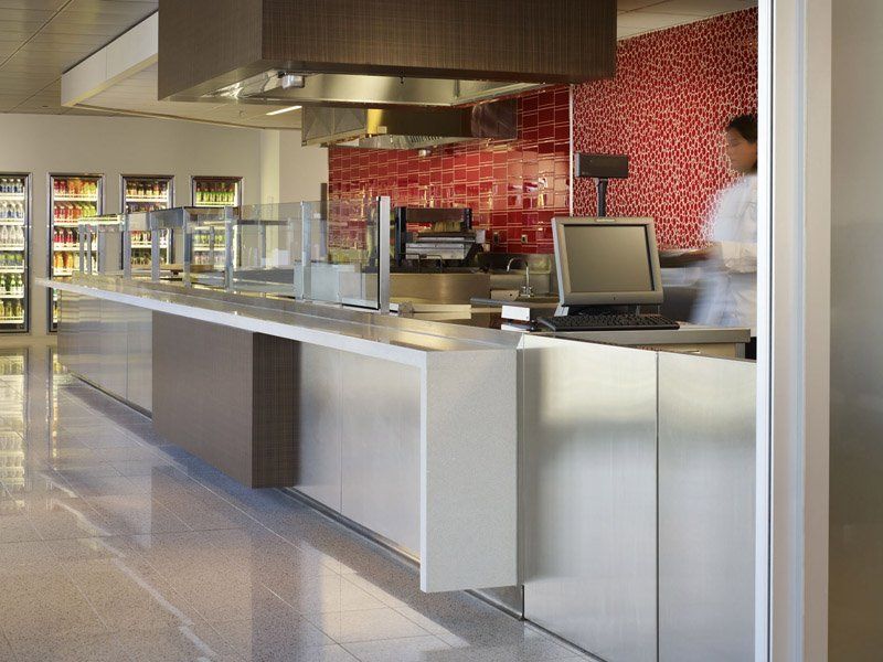 A long counter in a restaurant with a computer on it