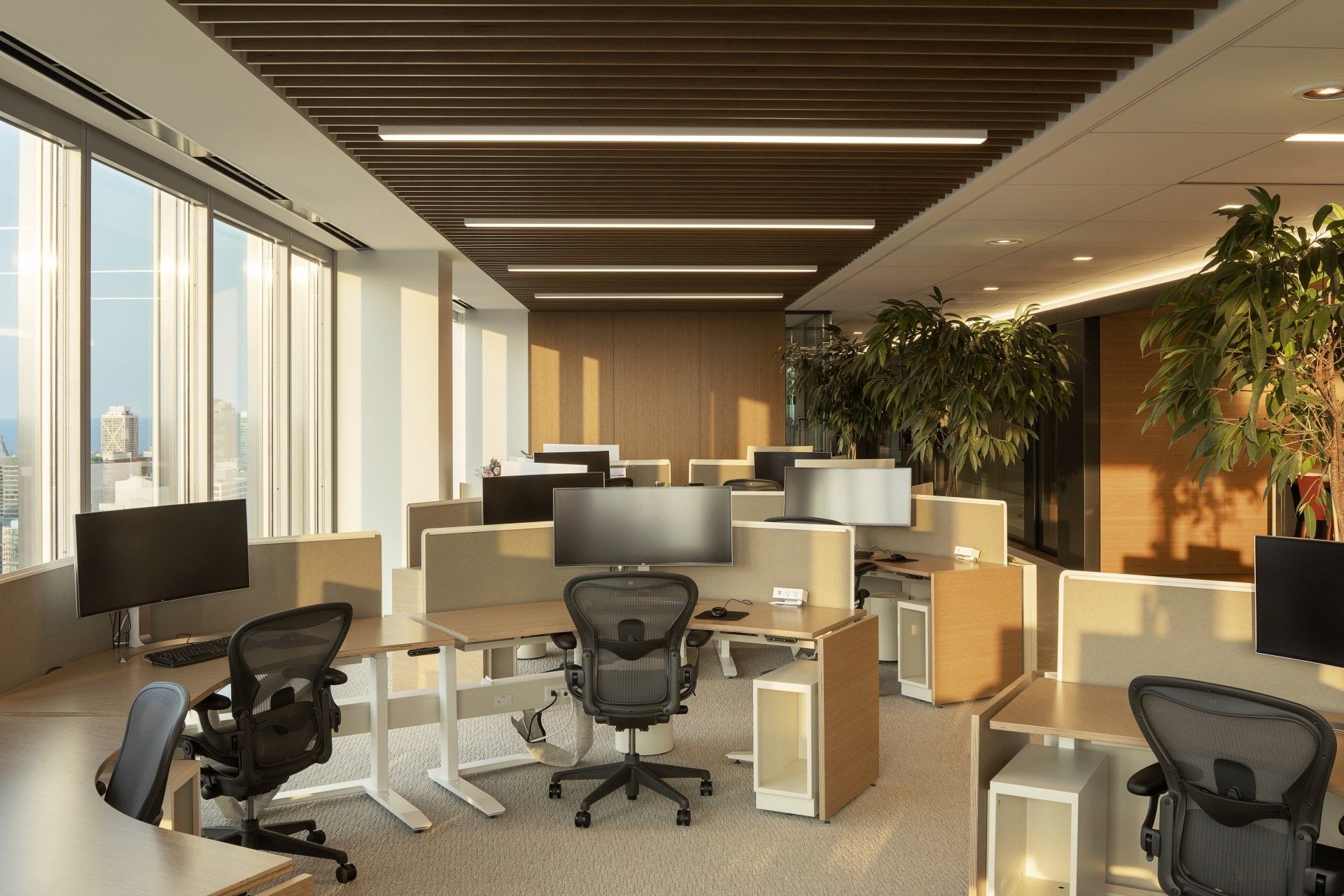 A large open office with lots of desks and chairs.