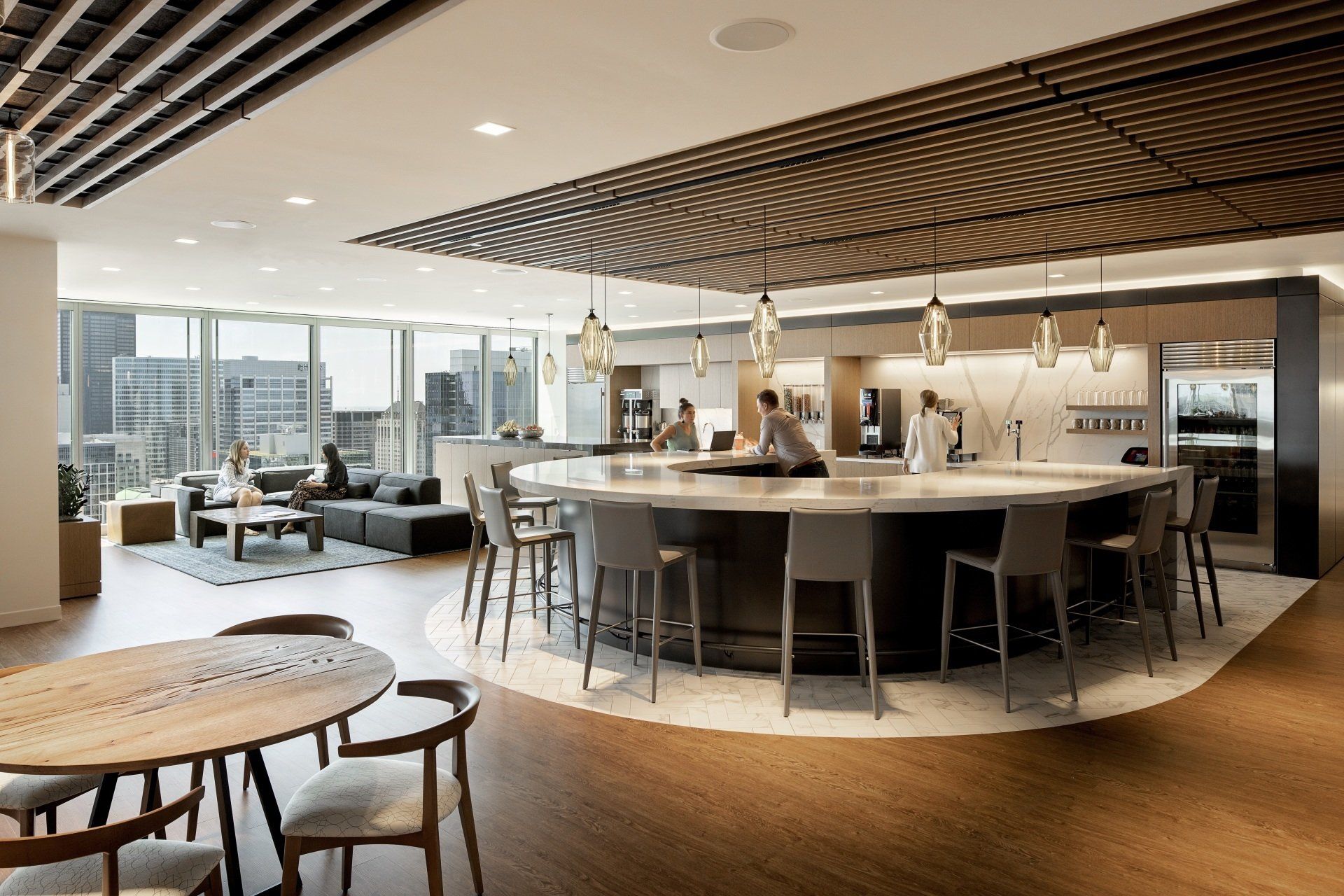 A large room with tables and chairs and a large counter.