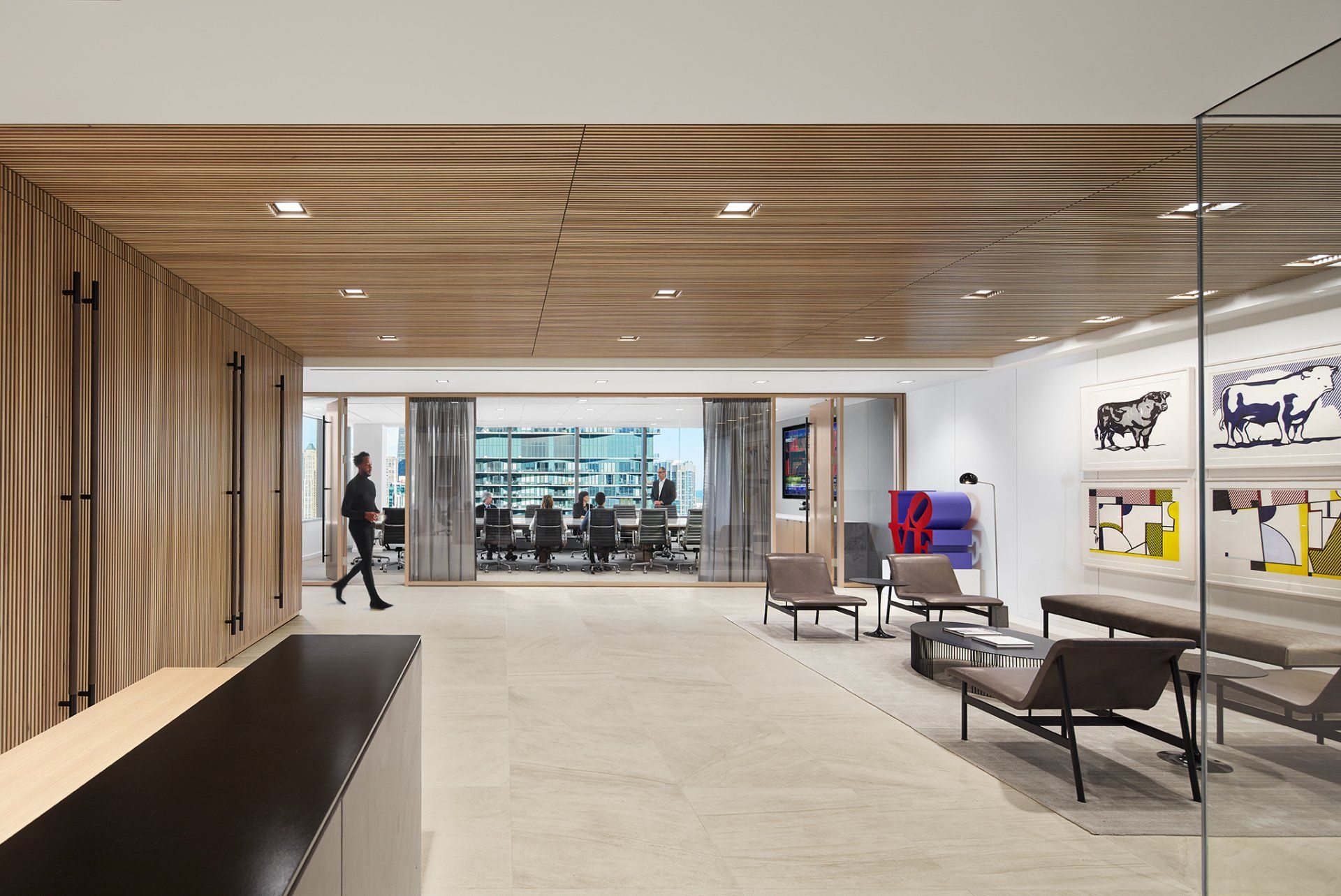 A man is walking through a lobby in an office building.