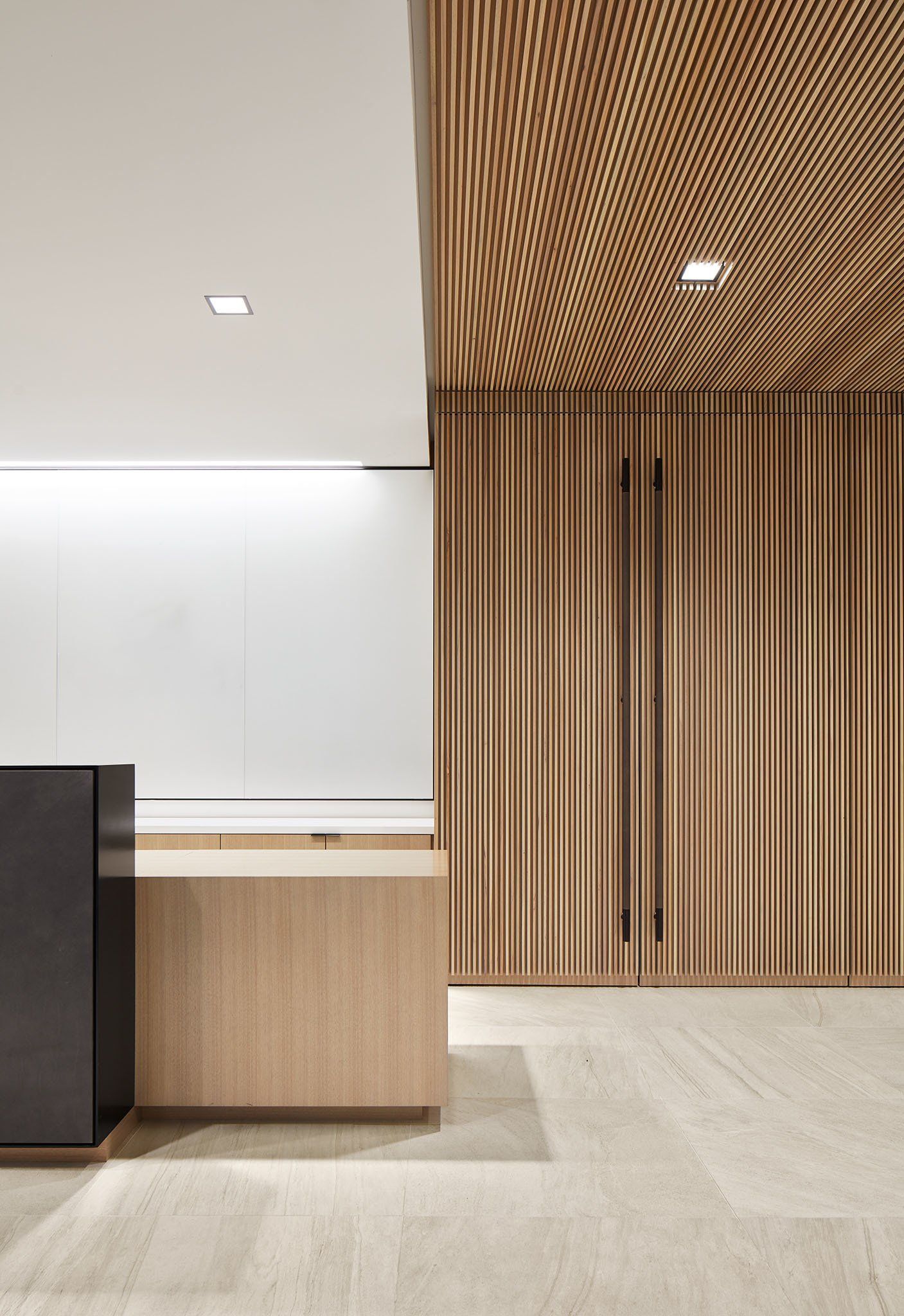 A reception area with a wooden ceiling and a wooden counter.